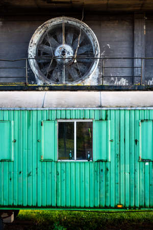 VÃ¶lklingen, Germany - November 7, 2019: lost place urban scene with green train car waggon...