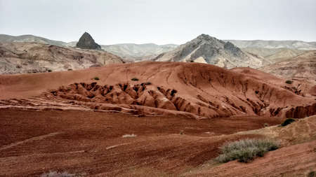 desert mountain range landscape in strange colors against an overcast sky, Rif mountains, Morocco