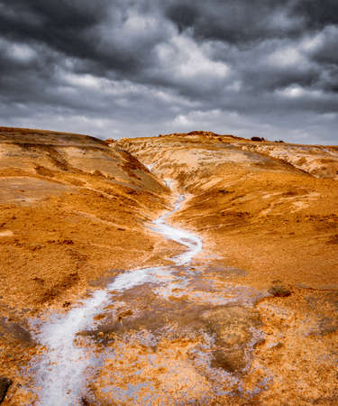 bright colorful salt desert landscape against dramatic cloudscape sky, Laayoune, Morocco