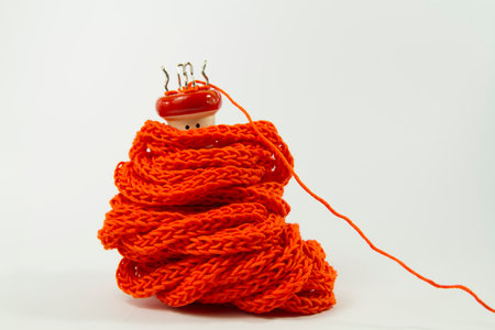 Wood spool knitter and bright orange yarnの写真素材