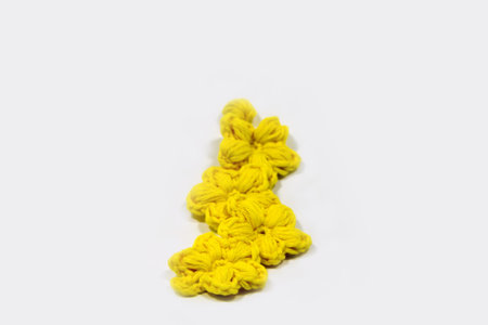 Yellow crochet flower bracelet isolatedの写真素材