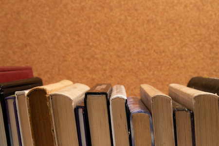 Hardcover books on a corkboard background