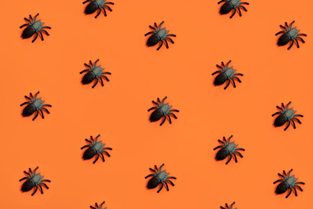 Spiders pattern on orange backgroundの写真素材