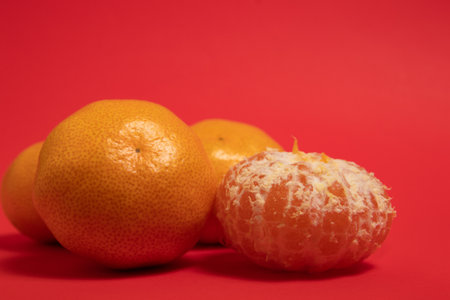 Mandarin oranges on a red backgroundの写真素材