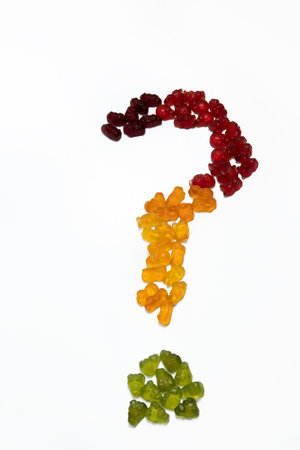 A question mark made of colorful gummy candies on white backgroundの写真素材