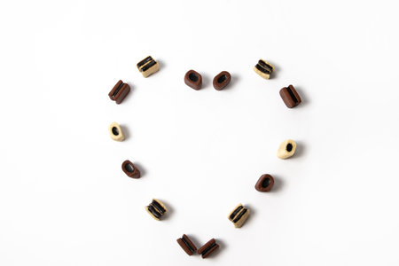 Heart shape of brown and white licorice candiesの写真素材