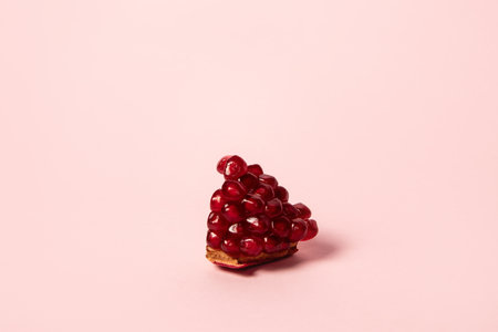 Ripe pomegranate fruits on pink background