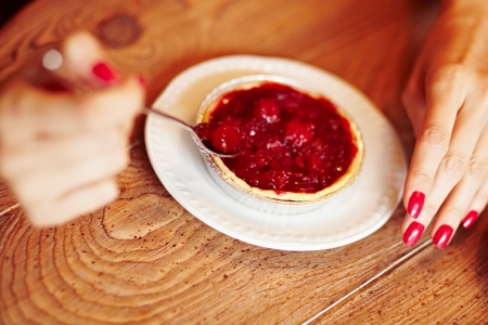 Tasting cherry pie with a spoonの写真素材