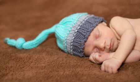 Baby boy sleeping on a carpet at homeの写真素材