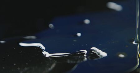 The waves on the water diverge in a circle, a drop of waterの写真素材