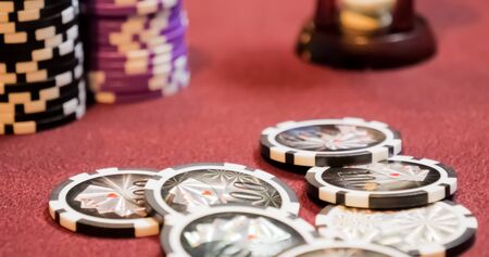Burgundy casino table. High contrast image of casino roulette and poker chipsの写真素材