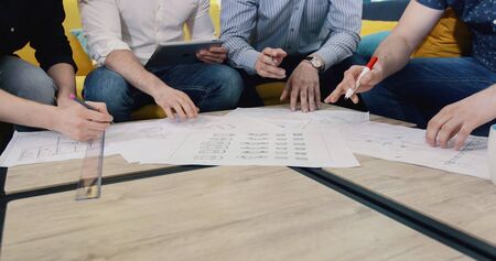 business, people, architecture and team work concept - close up of architects team hands pointing...