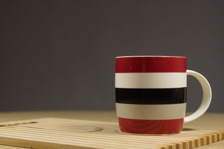 Red-white-blue mug on a blue background. The concept of a friendly company, a big family, meeting friends for a cup of tea or coffee, father's day, office, boss day.の写真素材