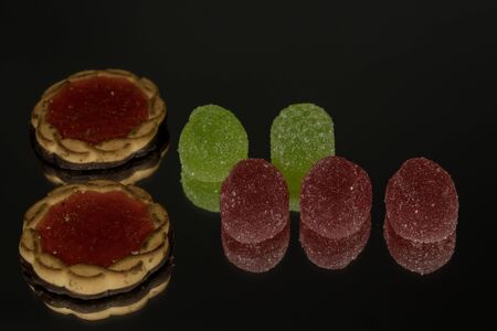 Several marmalade sweets isolated on a black mirror backgroundの写真素材