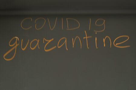 The inscription on the mirror - quarantine an inscription COVID-19 on mirror backgroundの写真素材