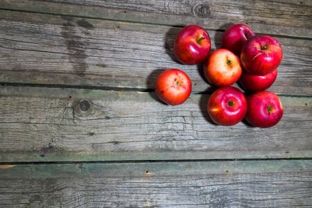 Red apples on wooden background. Copy space.の写真素材