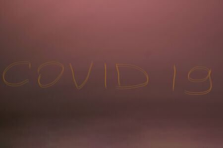 The inscription on the mirror an inscription COVID-19 on dark mirror background
