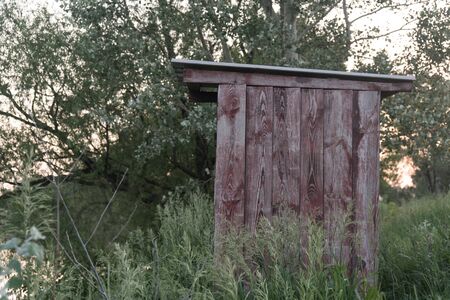 Old wooden double outhouse in the remote Russian village in the summerの写真素材