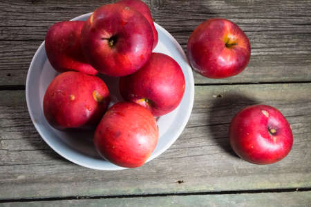 Red apples on wooden background. Copy space.の写真素材
