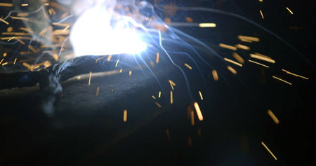 Welding of metal structures with sparks flying in the air.の写真素材
