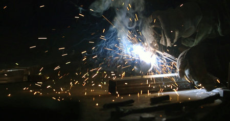 Welding of metal structures with sparks, close-up.