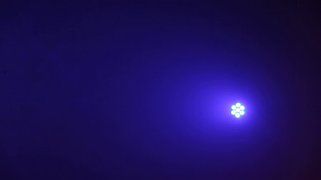 Blue light from the spotlights on a dark background. Abstract background Mirror disco ball in rays of light blue backgroundの写真素材