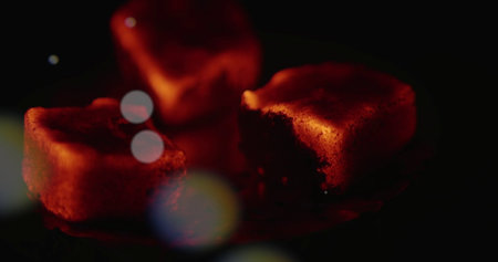 Cake with red color on a black background with bokeh