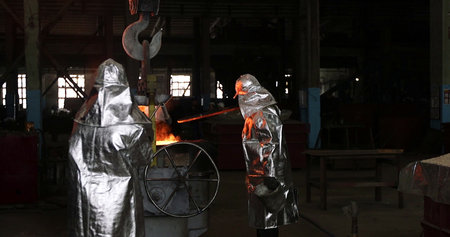 Welding work in a steel mill. The workers are welding metal.