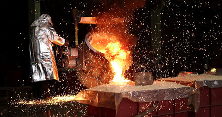 Industrial welding in a metallurgical plant with sparks flying.