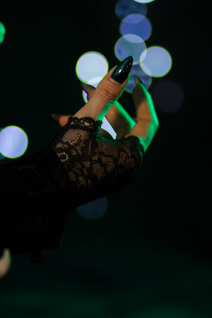 A hand in a lace glove in a magical glow
