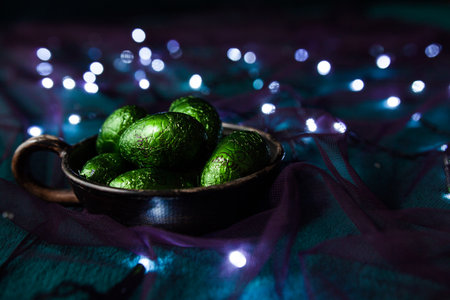 A plate of shiny green eggs among the garlands
