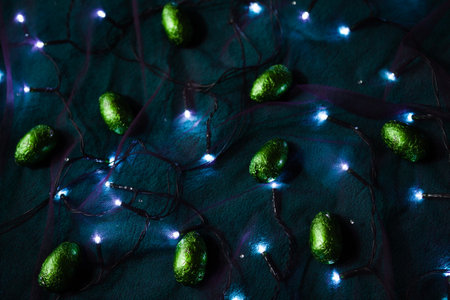 Sparkling green eggs among the lights of garland
