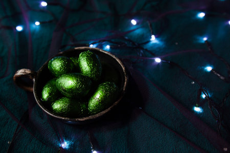 A plate of shiny green eggs among the garlands