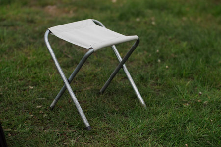 Folding Camping Chair Standing on Grassの写真素材