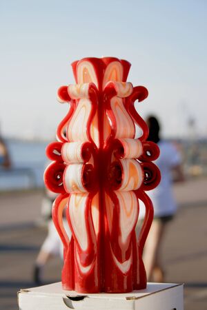 Handmade carved candles. Beautiful colour combination burgundy, white, orangeの写真素材