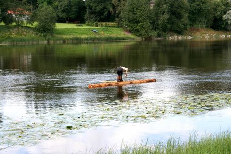 Old style travailing on the river on a logの写真素材