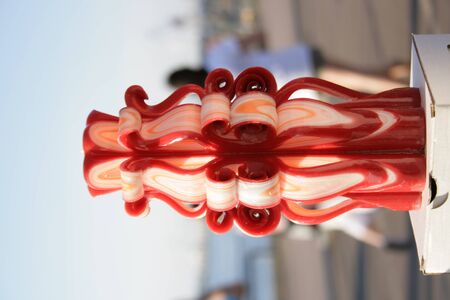 Handmade carved candles. Beautiful colour combination burgundy, white, orangeの写真素材