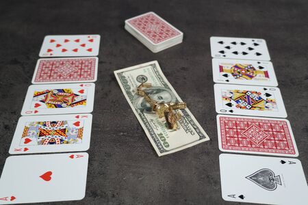 The combination of Flash Royal cards on a gray table with money and gold. Close-up. Poker gameの写真素材