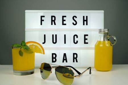 Fresh juice bar concept. Oranges with fresh orange juiceの写真素材