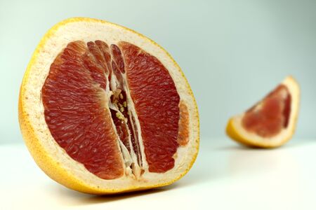 Grapefruit with grapefruit slice isolated on white background close up.の写真素材