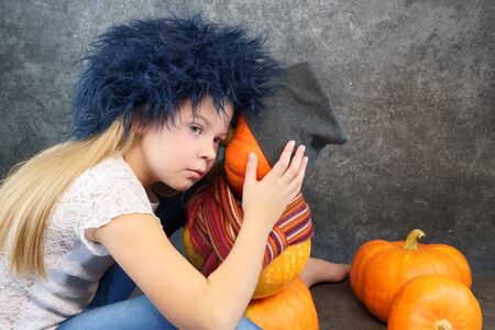 young girl with pumpkin. Friendship concept with emotions, no friends,nothing to do, lovely, in love, alone. for postcards, with copy spaceの写真素材