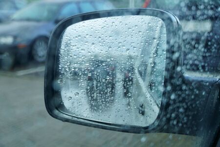 Raindrops on a car glass. Rainy autumn day, foggy windows and wet windows.の写真素材