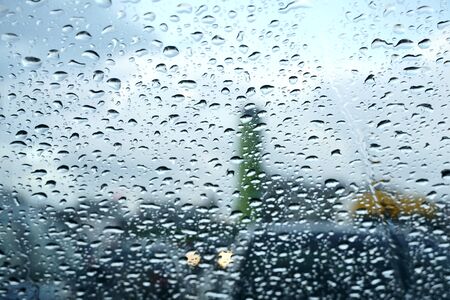 Raindrops on a car glass. Rainy autumn day, foggy windows and wet windows. Photoの写真素材