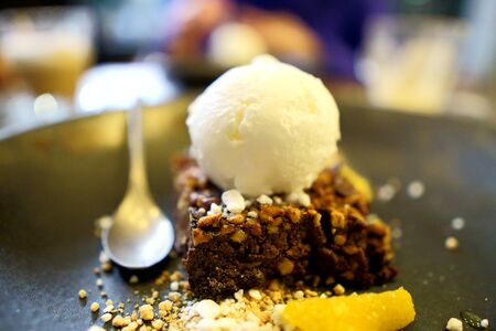 Dessert on a gray plate, delicious pie with a scoop of ice cream on top.の写真素材
