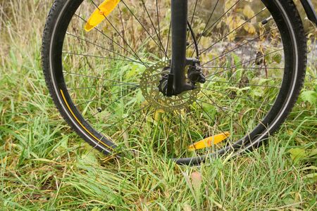 Close-up bicycle wheel on the river bank. photo