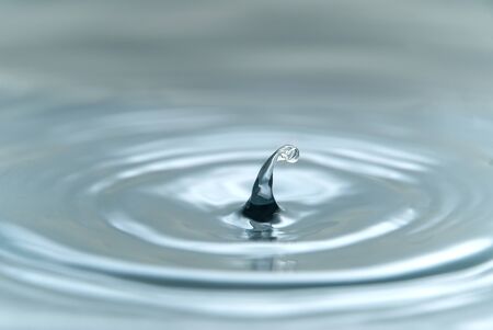 Beautiful splash of water drop on water surface, macro photoの写真素材