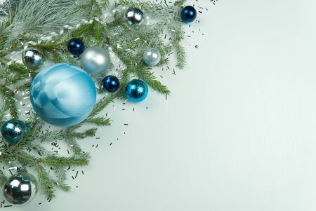Modern Christmas composition. Christmas balls, blue and silver decorations on white background. Flat lay, top view, copy space. close up photo. can be used us postcard or Christmas bannerの写真素材