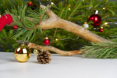 Beautiful Christmas composition. Gift boxes and christmas tree with lights on background. Xmas backdrop for your greeting card with space for text. Photo - imageの写真素材
