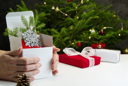 Beautiful Christmas composition. Gift boxes and christmas decor with christmas tree on background. Xmas backdrop for your greeting card with space for text.の写真素材