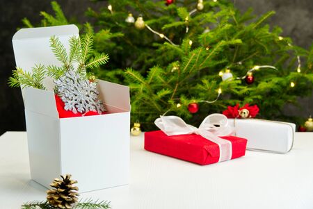 Beautiful Christmas composition. Gift boxes and christmas decor with christmas tree on background. Xmas backdrop for your greeting card with space for text.の写真素材